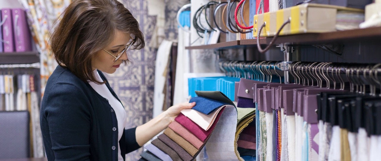 Woman looking at fabric swatches for custom curtains